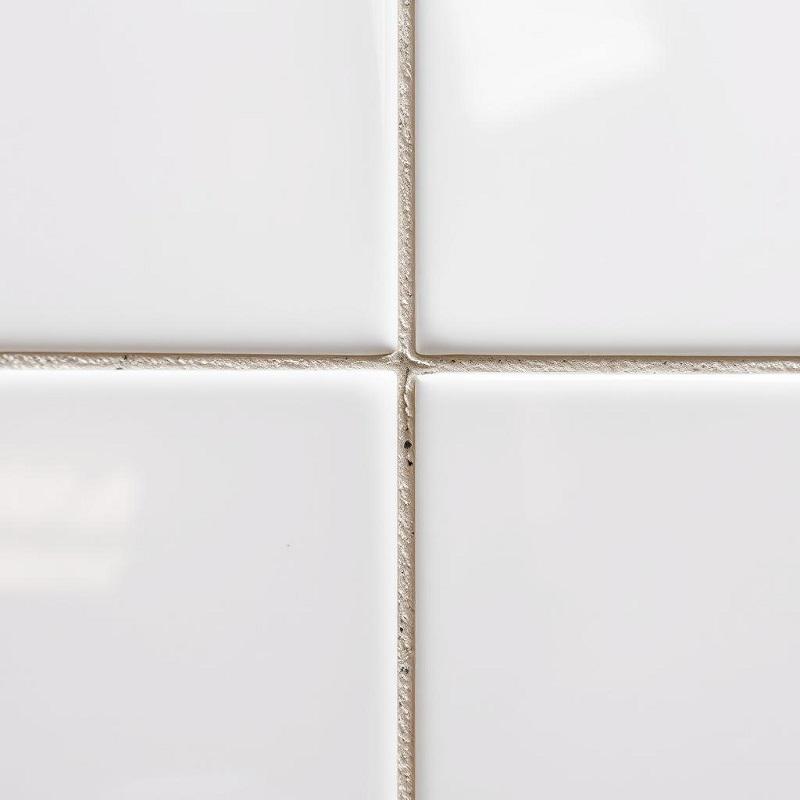 Unsanded tile grout in a bathroom setting showing smooth finish between tiles